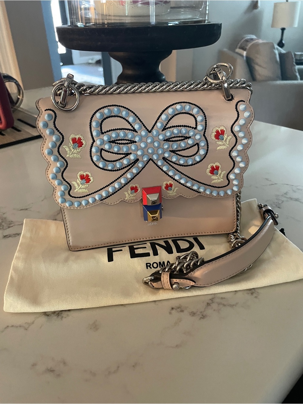 Fendi Kan I with s scalloped flap, light blue studded bow, and cube lock.
